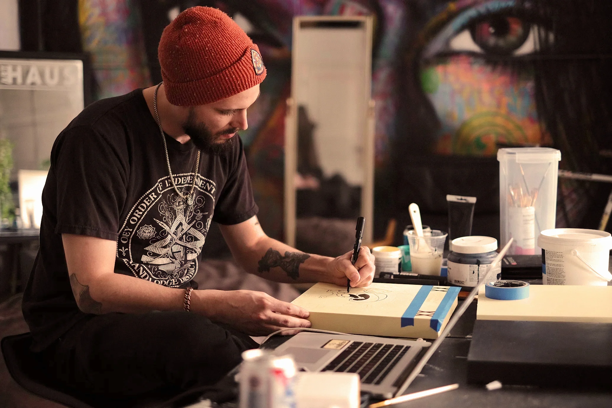 Artist drawing on a canvas in a studio