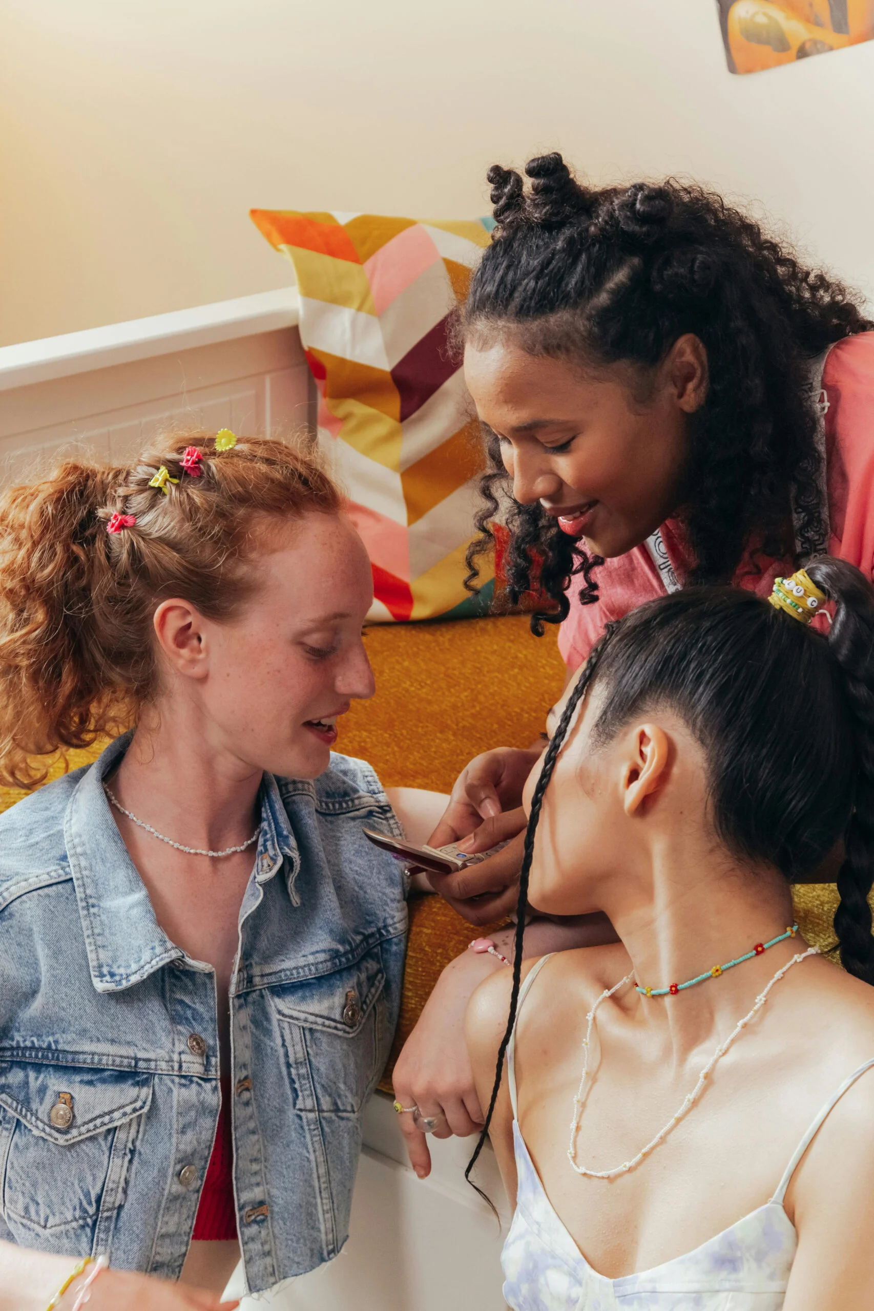 Group of friends gathered and looking at a phone